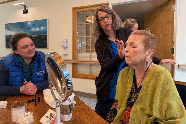 Hospice team members Morgan and Lisa help Lila with her makeup before heading out to the zoo.