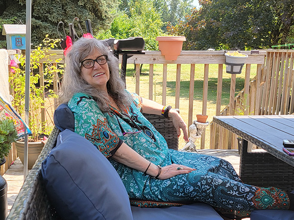 Housecall Providers Primary Care patient Linda Planque enjoys a sunny day from her cottage balcony.