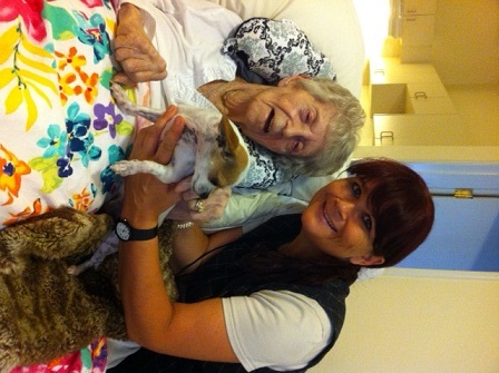 Hospice therapy dog Taquita enjoying some snuggle time with hospice patient Myrtle Gray and HCP volu