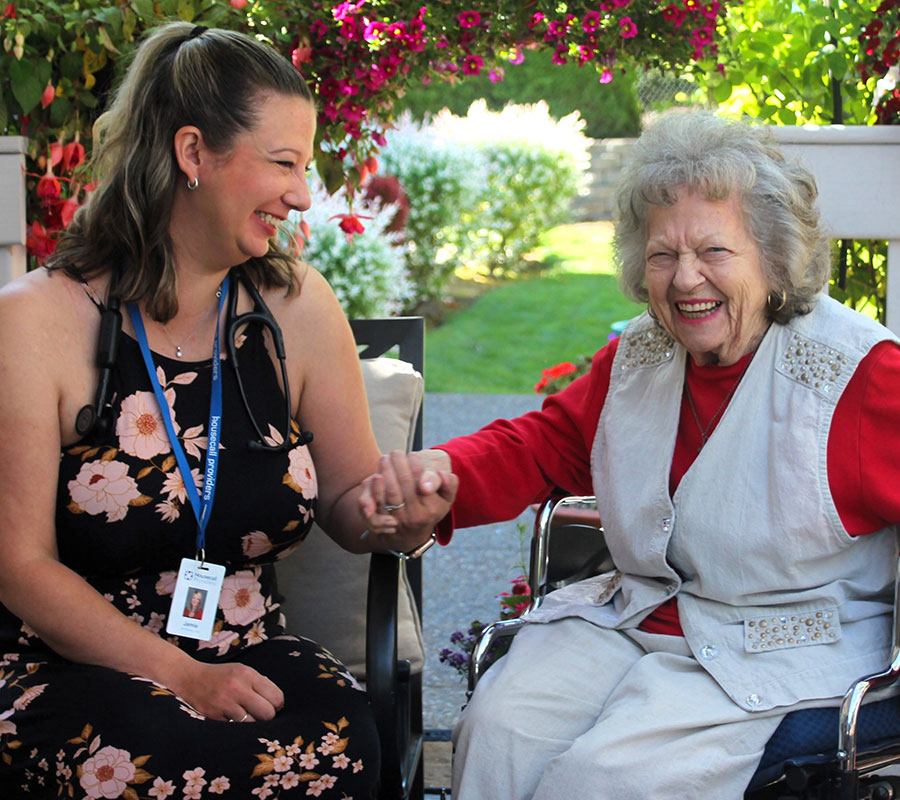 A Housecall Providers patient enjoys a house call outside on the patio