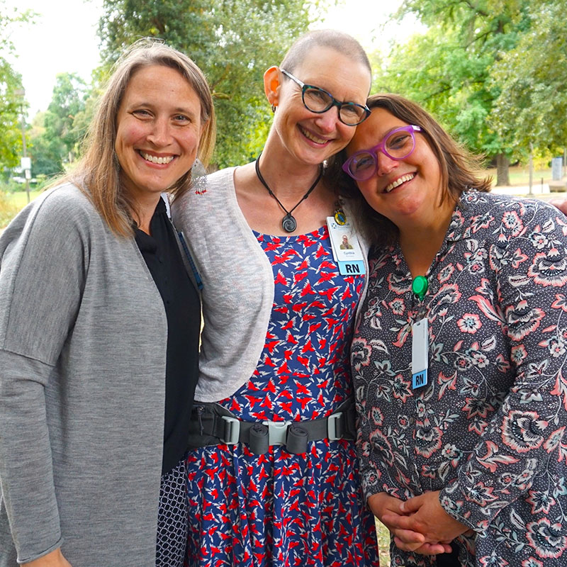 Housecall Providers Hospice team members smile for a photo in the park