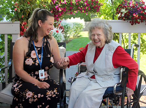 Primary care provider with her patient on the patio during a house call